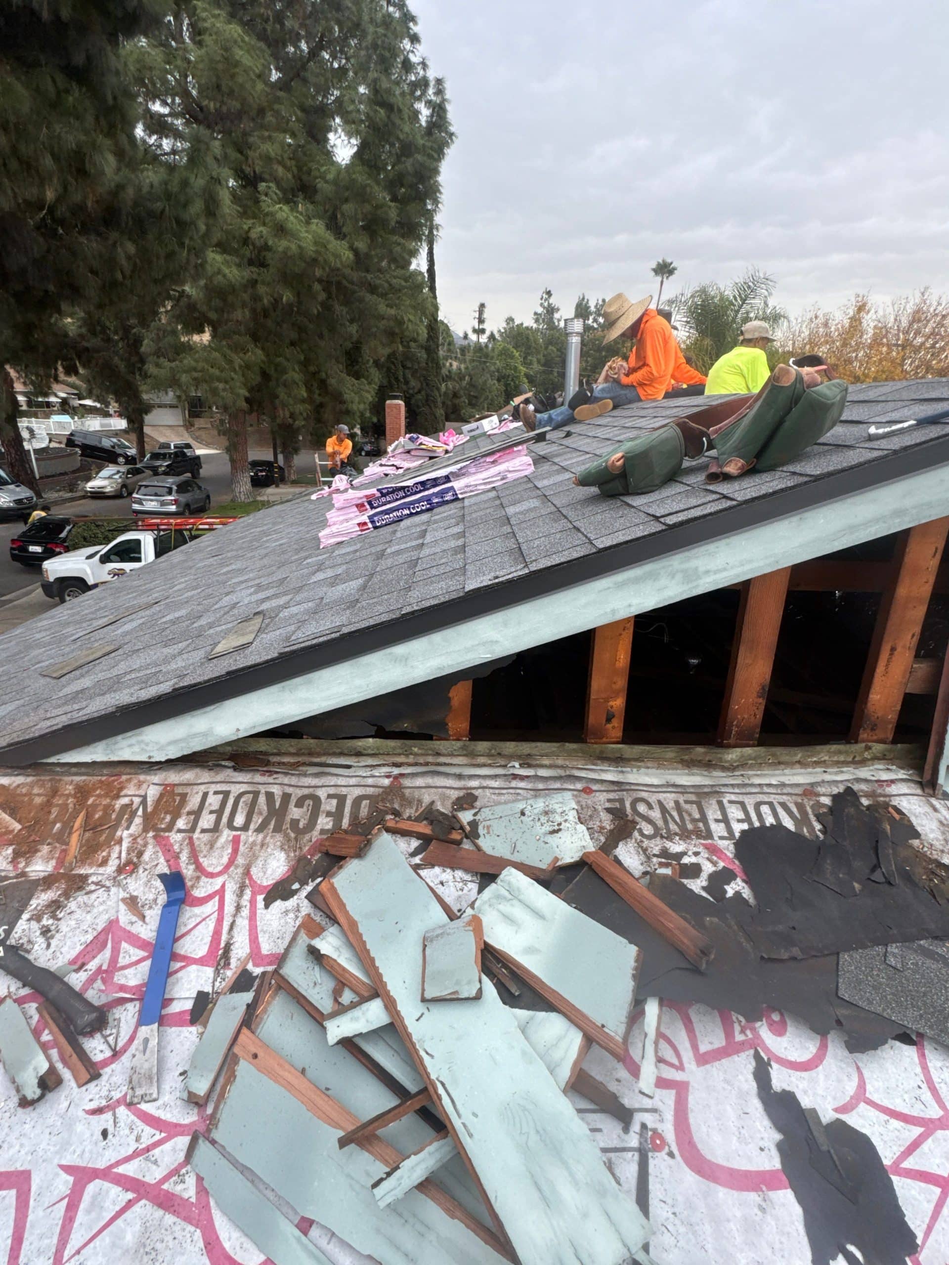 Roof Repairs CA team replacing damaged shingles in Burbank home