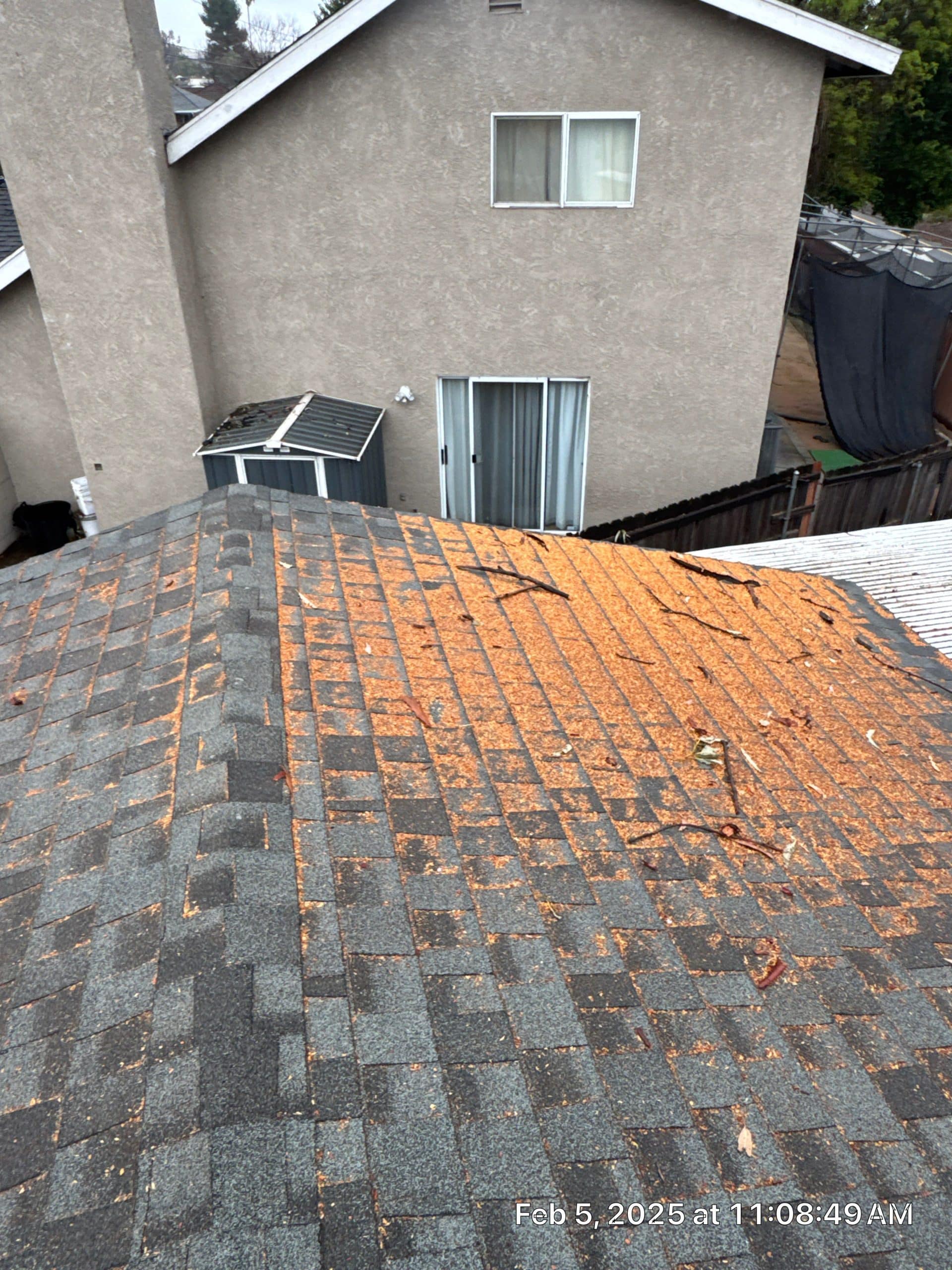 House roof with debris and visible damage.