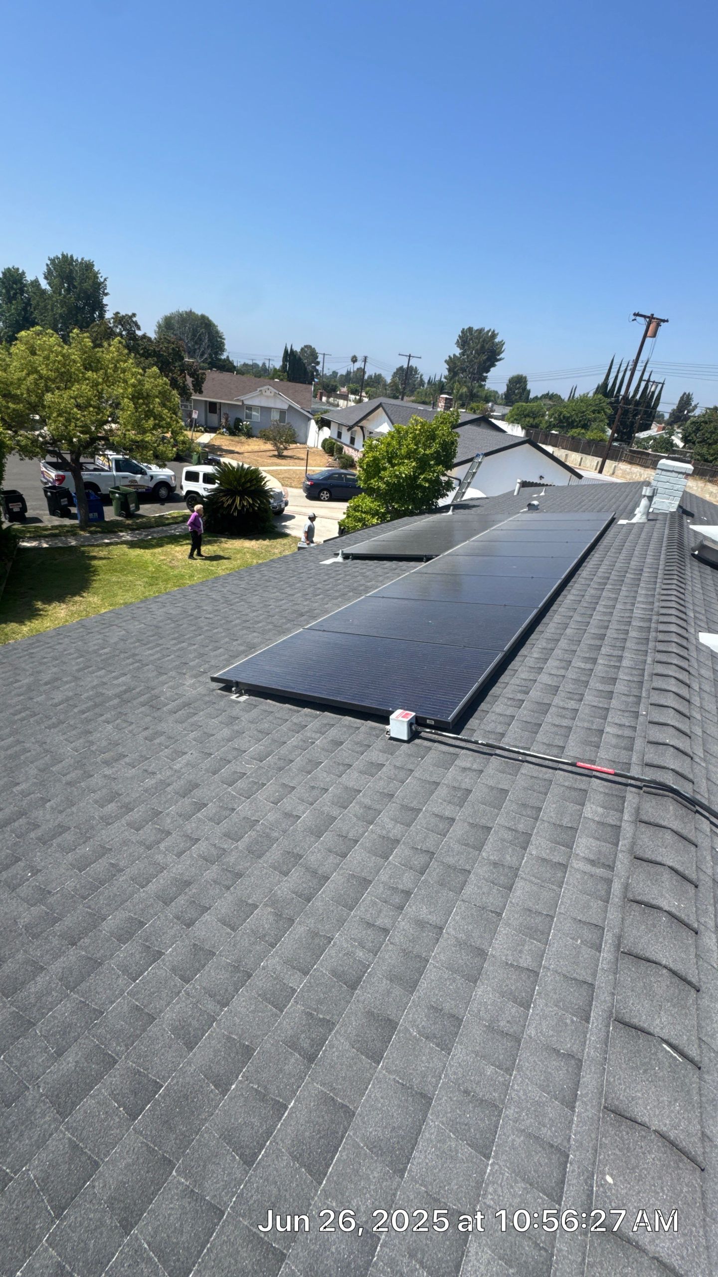 Rooftop solar panels on sunny suburban house.